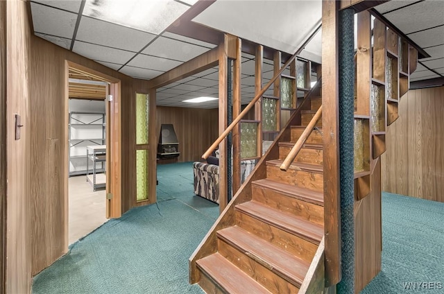 2923 N Ave, Niagara Falls, NY 14305 - stairway featuring carpet flooring, a drop ceiling, and wooden walls