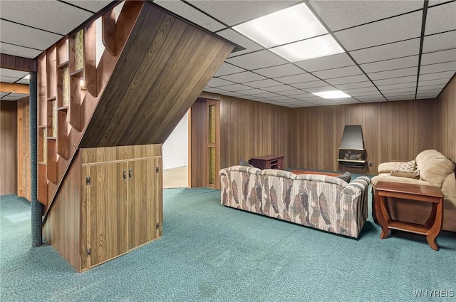 2923 N Ave, Niagara Falls, NY 14305 - living area with carpet flooring, wood walls, stairs, and a drop ceiling