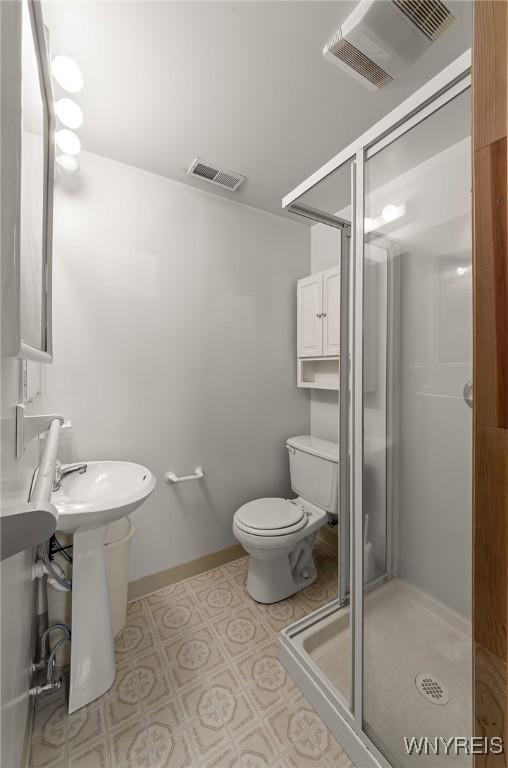 2923 N Ave, Niagara Falls, NY 14305 - full bathroom featuring a shower stall, toilet, and tile patterned floors