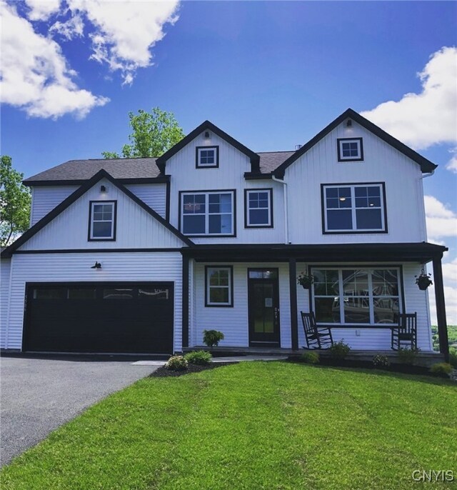 213 Lexi Ln, Van Buren, NY 13027 - view of front of home with a porch, a front yard, asphalt driveway, and an attached garage