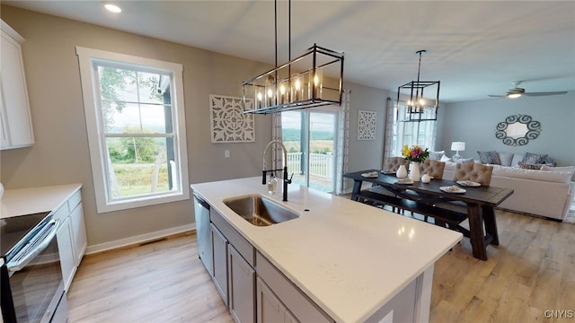 213 Lexi Ln, Van Buren, NY 13027 - kitchen with stainless steel appliances, a sink, light wood-style flooring, open floor plan, and light countertops