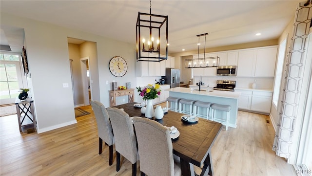 213 Lexi Ln, Van Buren, NY 13027 - dining space featuring light wood-style flooring, a chandelier, baseboards, and recessed lighting