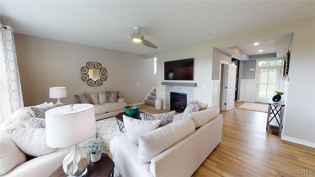 213 Lexi Ln, Van Buren, NY 13027 - living area featuring light wood finished floors, ceiling fan, baseboards, and a stone fireplace