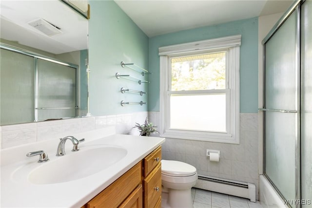 24 Glenbourne Ct, Amherst, NY 14221 - bathroom featuring baseboard heating, tile walls, vanity, toilet, and tile patterned floors