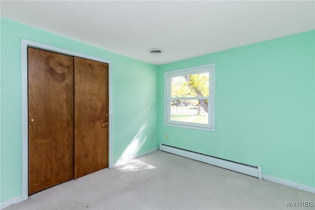 24 Glenbourne Ct, Amherst, NY 14221 - unfurnished bedroom featuring a baseboard heating unit, carpet, and baseboards