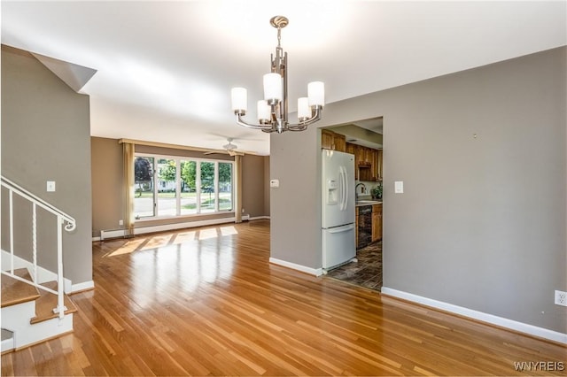 24 Glenbourne Ct, Amherst, NY 14221 - unfurnished dining area featuring a chandelier, light wood-style flooring, stairs, a baseboard radiator, and a sink