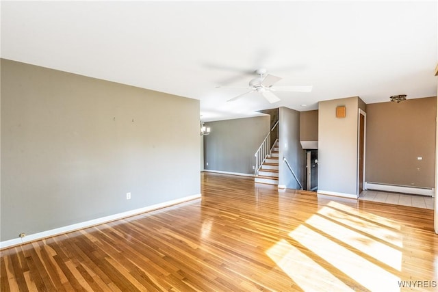 24 Glenbourne Ct, Amherst, NY 14221 - unfurnished room featuring a baseboard heating unit, baseboards, wood finished floors, and ceiling fan