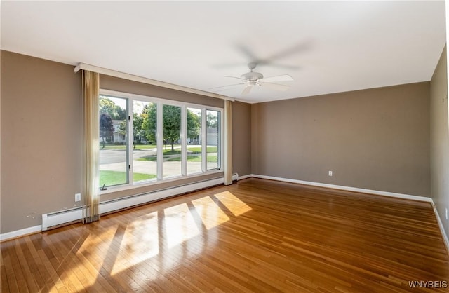 24 Glenbourne Ct, Amherst, NY 14221 - unfurnished room featuring a baseboard heating unit, a ceiling fan, baseboards, and wood-type flooring