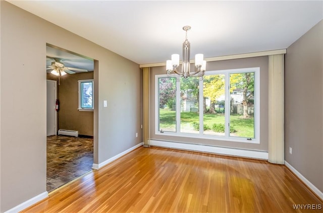 24 Glenbourne Ct, Amherst, NY 14221 - unfurnished dining area featuring a baseboard heating unit, a chandelier, light wood-style flooring, a baseboard radiator, and baseboards