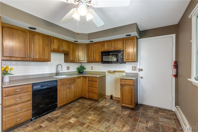 24 Glenbourne Ct, Amherst, NY 14221 - kitchen with black appliances, a baseboard heating unit, a sink, brown cabinets, and tasteful backsplash