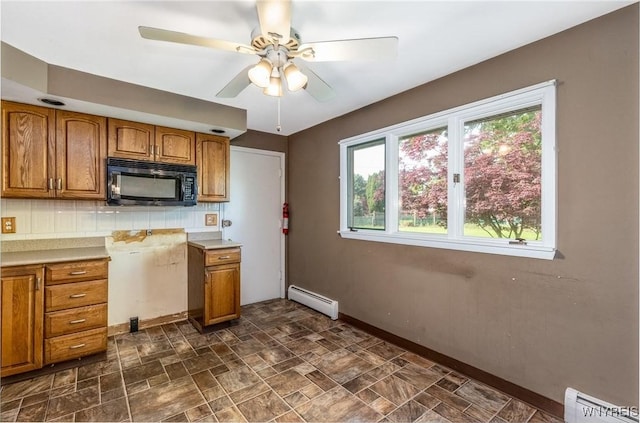 24 Glenbourne Ct, Amherst, NY 14221 - kitchen with black microwave, a baseboard radiator, brown cabinetry, and baseboards