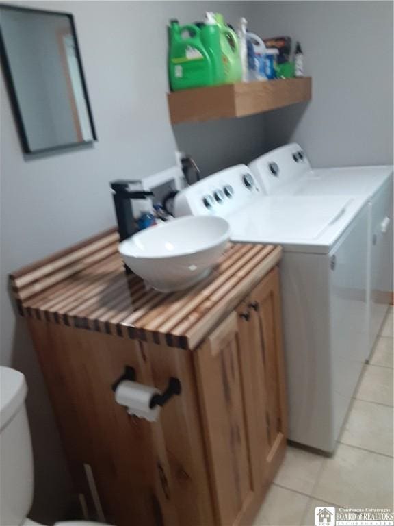 9165 Hebner Hill Rd, Otto, NY 14719 - laundry area with washing machine and dryer and light tile patterned floors