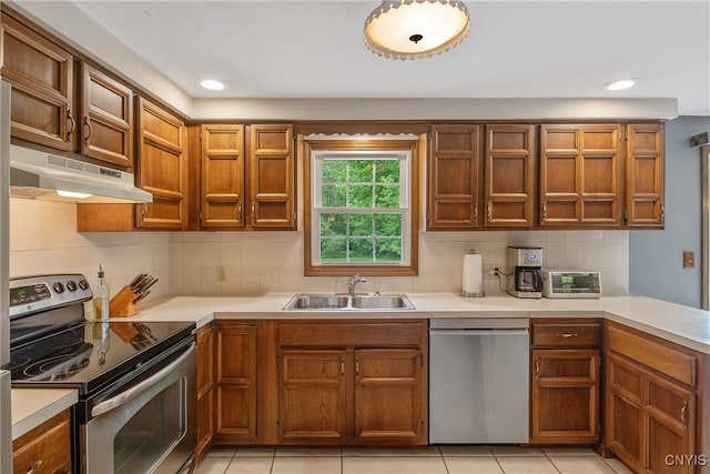 8974 Fenner Rd, Lysander, NY 13027 - kitchen with stainless steel appliances, a sink, under cabinet range hood, light countertops, and recessed lighting
