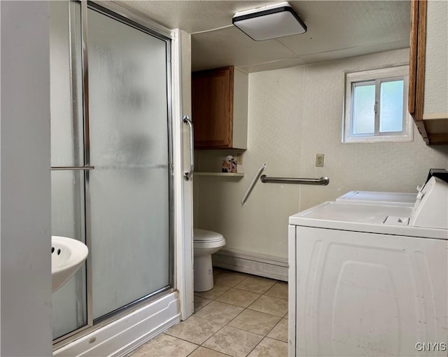 725 Emery St, Fulton, NY 13069 - bathroom featuring a shower with door, baseboard heating, washer and clothes dryer, toilet, and tile patterned flooring