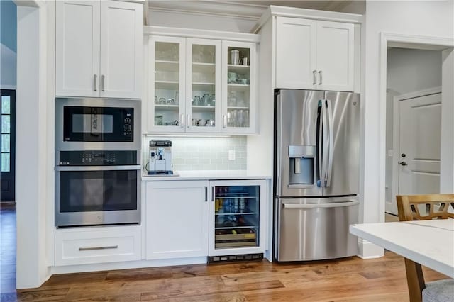 101 Coventry Rdg, Pittsford, NY 14534 - kitchen with stainless steel appliances, beverage cooler, white cabinetry, glass insert cabinets, and decorative backsplash