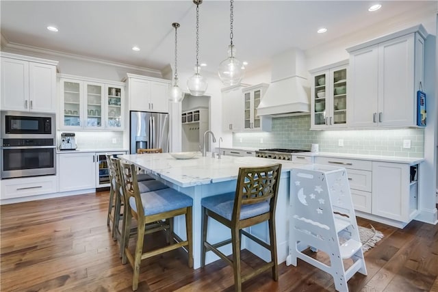 101 Coventry Rdg, Pittsford, NY 14534 - kitchen with stainless steel appliances, custom exhaust hood, backsplash, wine cooler, and a breakfast bar area
