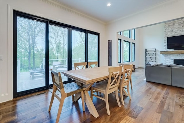 101 Coventry Rdg, Pittsford, NY 14534 - dining space with crown molding, a fireplace, wood finished floors, and recessed lighting