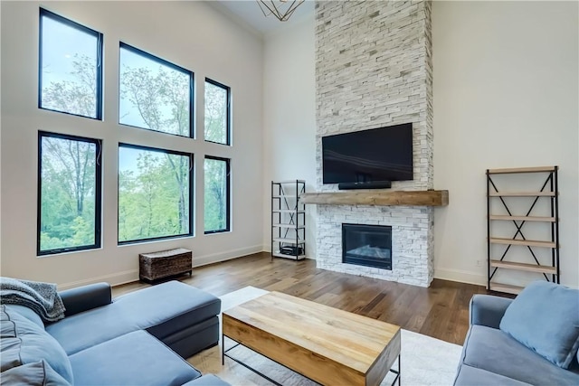 101 Coventry Rdg, Pittsford, NY 14534 - living area featuring a high ceiling, wood finished floors, baseboards, and a fireplace