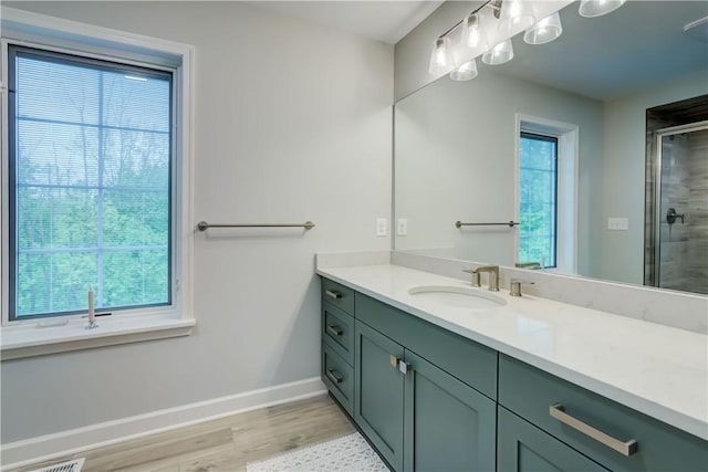 101 Coventry Rdg, Pittsford, NY 14534 - bathroom with baseboards, vanity, a stall shower, and wood finished floors
