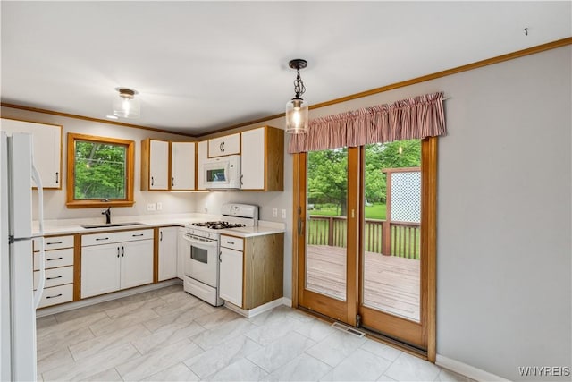 75 Greenmeadow Dr, West Seneca, NY 14224 - kitchen featuring white appliances, a sink, light countertops, healthy amount of natural light, and crown molding