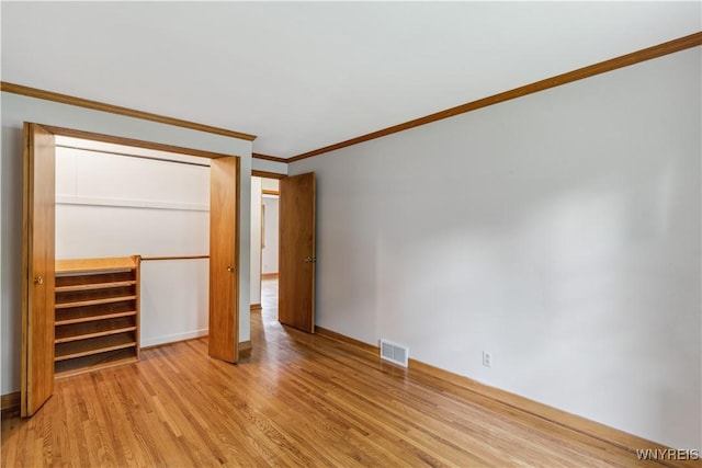 75 Greenmeadow Dr, West Seneca, NY 14224 - unfurnished bedroom featuring crown molding, light wood-type flooring, baseboards, and a closet