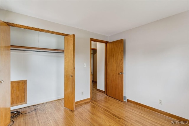75 Greenmeadow Dr, West Seneca, NY 14224 - unfurnished bedroom with wood finished floors, baseboards, and a closet