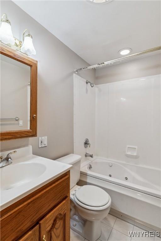 75 Greenmeadow Dr, West Seneca, NY 14224 - full bath with vanity, tile patterned flooring, a combined bath / shower with jetted tub, and toilet