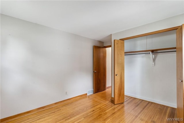 75 Greenmeadow Dr, West Seneca, NY 14224 - unfurnished bedroom with light wood-type flooring, a closet, and baseboards