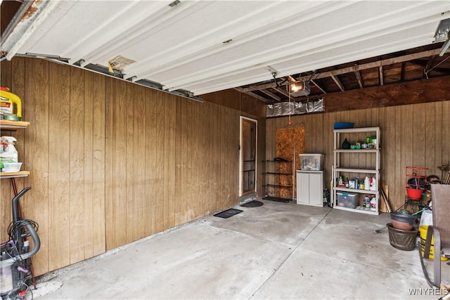 75 Greenmeadow Dr, West Seneca, NY 14224 - garage with wood walls and a garage door opener