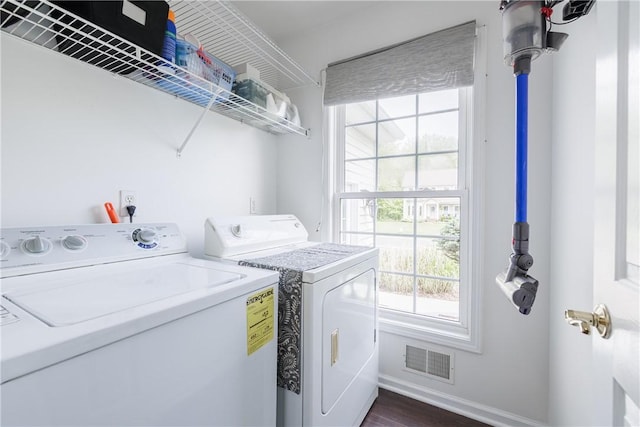1156 Channing Woods Dr, Webster, NY 14580 - laundry area featuring washing machine and dryer, plenty of natural light, baseboards, and dark wood-type flooring
