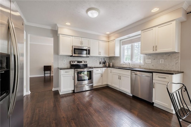 1156 Channing Woods Dr, Webster, NY 14580 - kitchen featuring stainless steel appliances, dark countertops, a sink, dark wood-style flooring, and ornamental molding