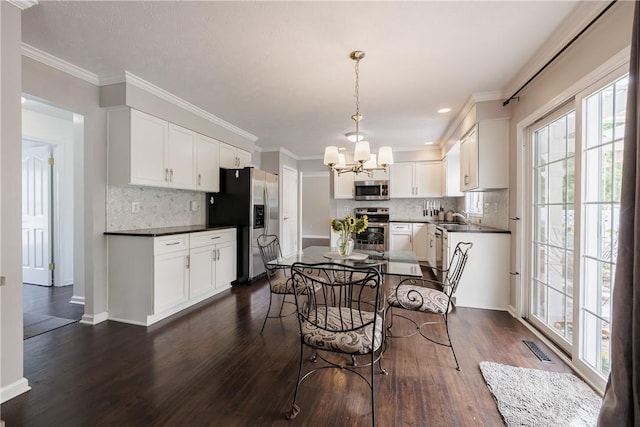 1156 Channing Woods Dr, Webster, NY 14580 - dining space with a chandelier, plenty of natural light, dark wood-style floors, baseboards, and ornamental molding