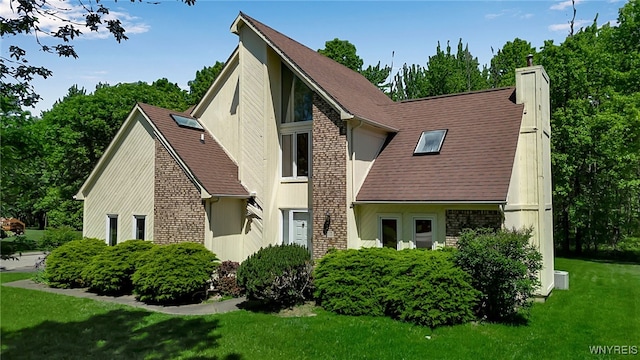 113 Meadow Spring Ln, Amherst, NY 14051 - view of front facade with a chimney, a front lawn, and a shingled roof