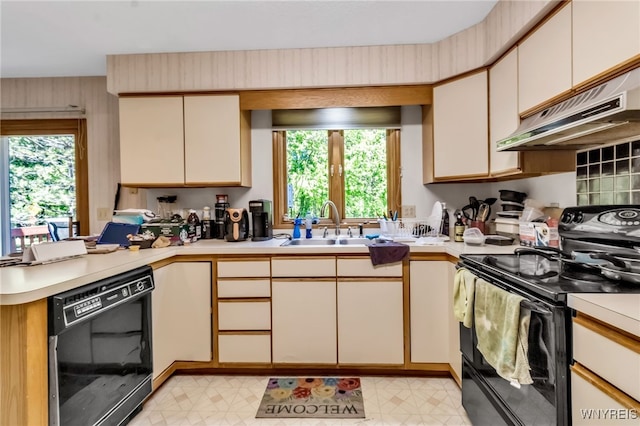 113 Meadow Spring Ln, Amherst, NY 14051 - kitchen featuring black appliances, a peninsula, light countertops, and ventilation hood
