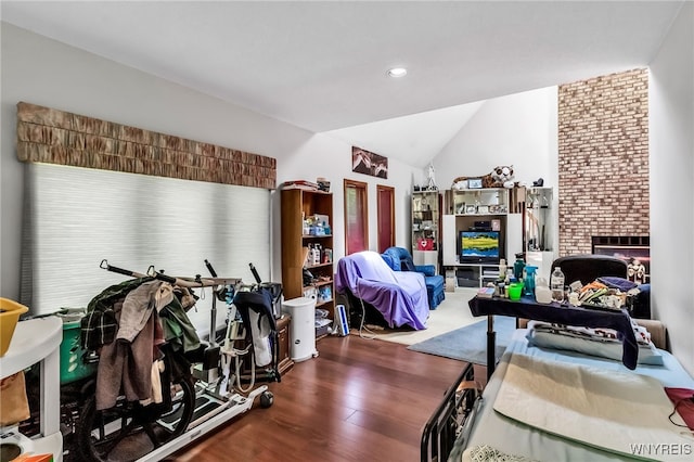 113 Meadow Spring Ln, Amherst, NY 14051 - living area with wood finished floors, vaulted ceiling, a fireplace, and recessed lighting