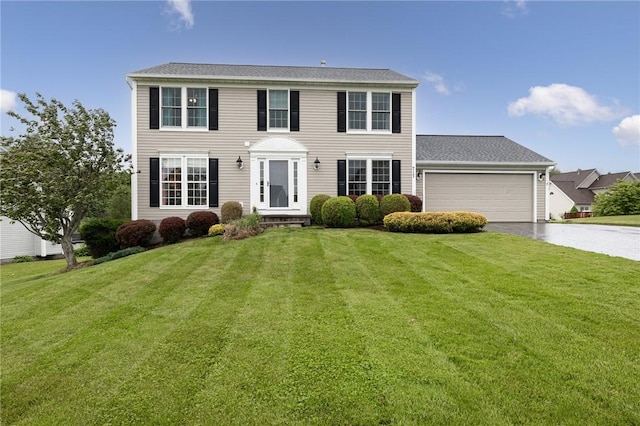 717 Westwood Trl, Walworth, NY 14502 - colonial house featuring concrete driveway, an attached garage, and a front yard