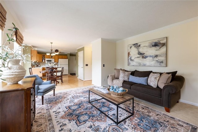 717 Westwood Trl, Walworth, NY 14502 - living room with crown molding, a chandelier, and baseboards