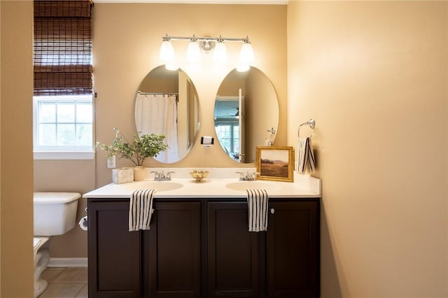 717 Westwood Trl, Walworth, NY 14502 - full bath featuring toilet, double vanity, tile patterned flooring, and baseboards