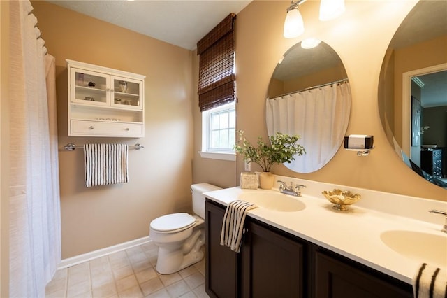 717 Westwood Trl, Walworth, NY 14502 - bathroom with toilet, double vanity, and baseboards