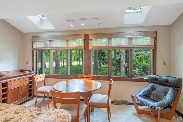 8807 Wandering Way, Lysander, NY 13027 - dining room featuring a skylight, track lighting, and light tile patterned flooring