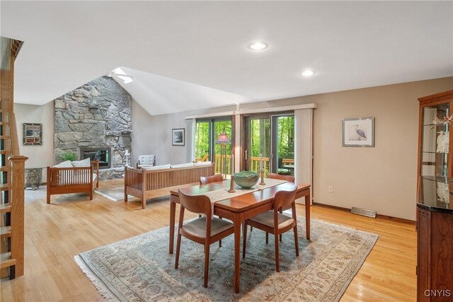 8807 Wandering Way, Lysander, NY 13027 - dining room featuring light wood-style floors, baseboards, a stone fireplace, and recessed lighting