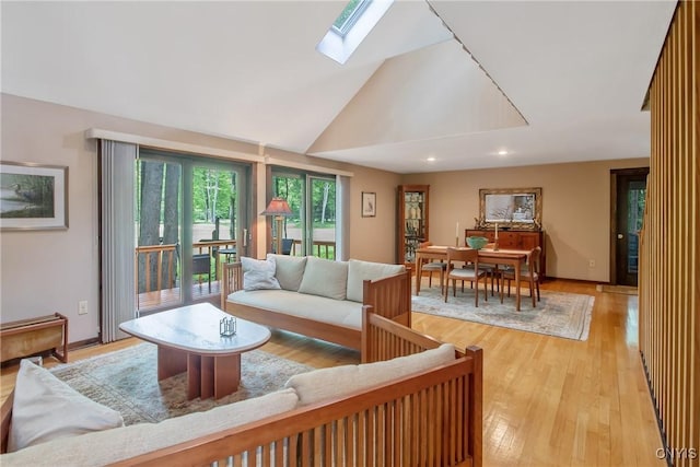 8807 Wandering Way, Lysander, NY 13027 - living area featuring a skylight, light wood-style floors, lofted ceiling, and recessed lighting
