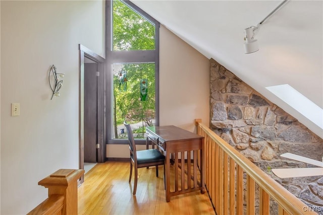 8807 Wandering Way, Lysander, NY 13027 - dining space featuring light wood finished floors, lofted ceiling, and a skylight