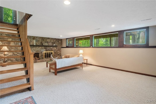 8807 Wandering Way, Lysander, NY 13027 - bedroom with carpet flooring, multiple windows, baseboards, recessed lighting, and a stone fireplace
