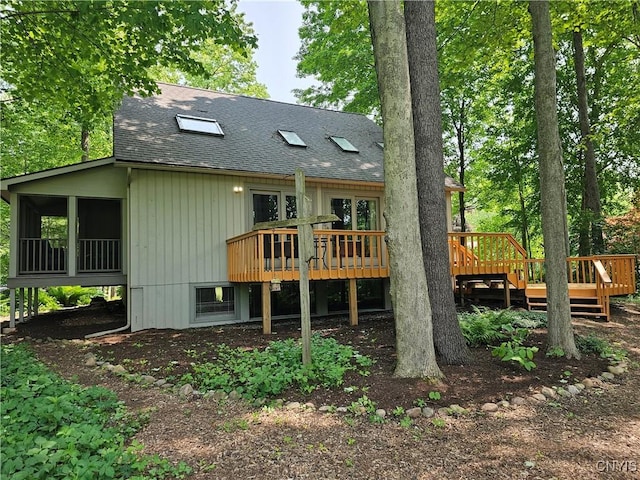 8807 Wandering Way, Lysander, NY 13027 - rear view of house with roof with shingles, a wooden deck, and a sunroom