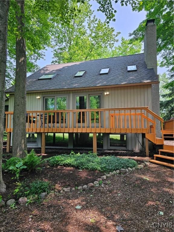 8807 Wandering Way, Lysander, NY 13027 - rear view of house with a deck, stairs, and roof with shingles