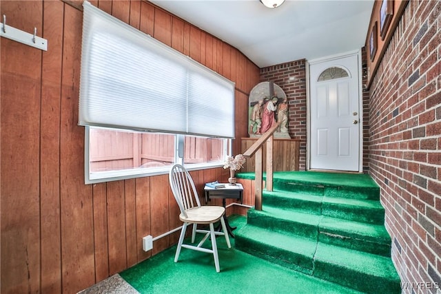 73 Stevenson Blvd, Amherst, NY 14226 - staircase featuring brick wall, carpet floors, and wood walls