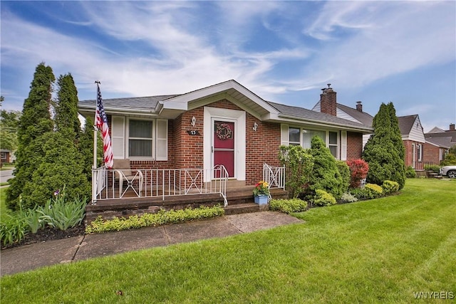 73 Stevenson Blvd, Amherst, NY 14226 - view of front of home with brick siding, a front yard, a chimney, and covered porch