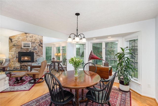 716 Mariner Cir, Webster, NY 14580 - dining space with plenty of natural light, light wood-type flooring, a fireplace, and baseboards