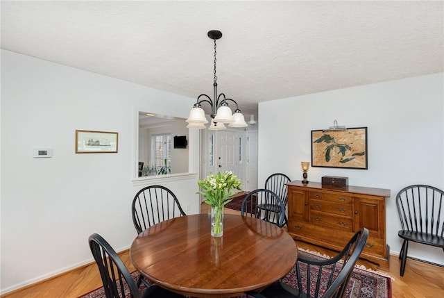 716 Mariner Cir, Webster, NY 14580 - dining area featuring light wood-style flooring, a chandelier, baseboards, and a textured ceiling